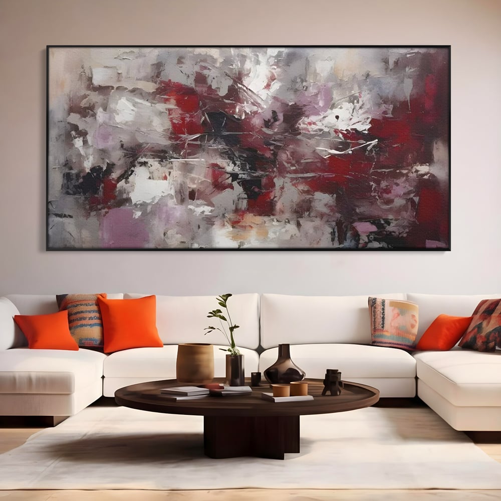 Tablou canvas cu pictura abstracta cu pete rosii, in rama de aluminiu negru, pe perete intr-un living